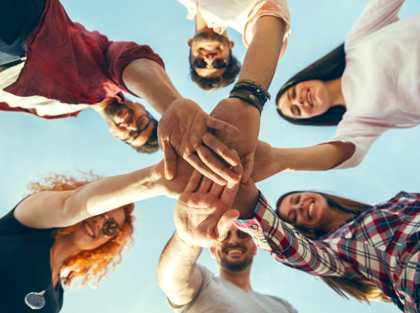 istock Group of young people standing in a circle, outdoors, having fun 690900096