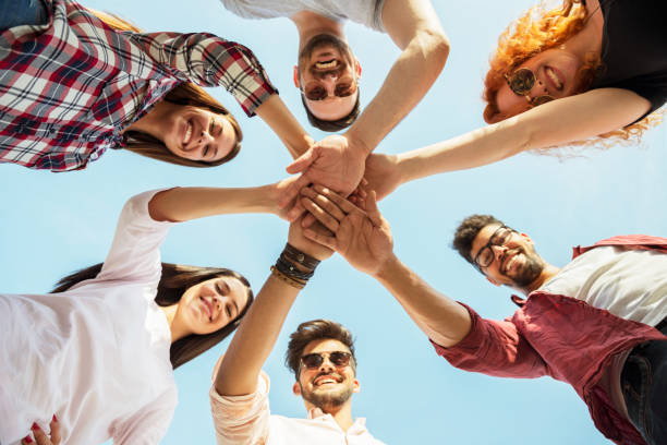 istock Group of young people standing in a circle, outdoors, having fun 690900194
