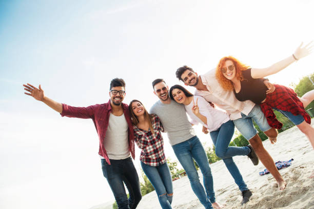 istock Group of young people having fun outdoors on the beach 690900388