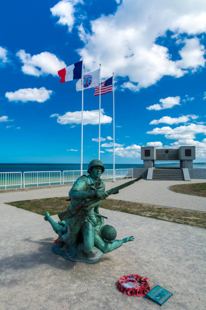 Omaha Beach, Colleville-sur-Mer, France, September 01, 2019:  Looking at the 1st US Infantry Division Memorial at Omaha Beach, Colleville-sur-Mer, Calvados, Normandy, France. The obelisk stands in the middle of the area of Wiederstandsnest (WN62). WN62 was one of the strongest defending positions in that area. The WN62-area is dotted with casemates, tobruks, trenches and other defense objects.