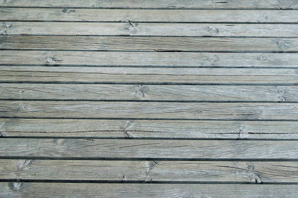 istock Old dark grey wooden fence background texture 690903664