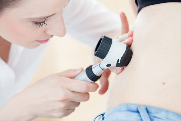 istock Dermatologist Inspecting Patient Skin Moles 690903752
