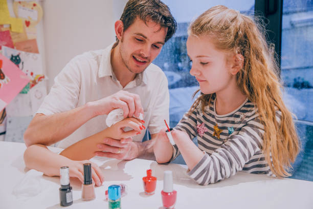 istock Father Helping his Daughter Paint her Prosthetic Limb Nails 690904406