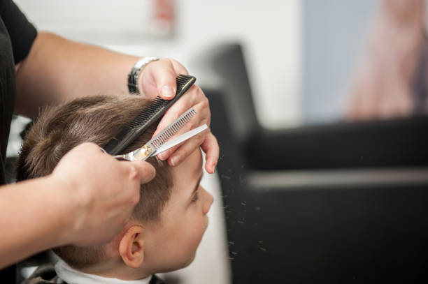istock High Angle View Of Boy Getting Haircut 690906808