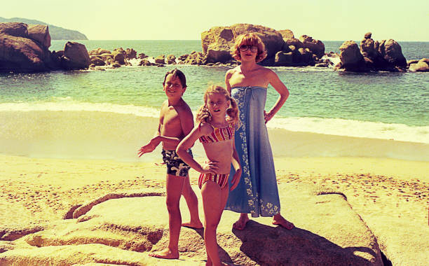 Vintage family vacations in Acapulco Vintage photo featuring a mother and her children at the Acapulco beach. mexico state photos stock pictures, royalty-free photos & images