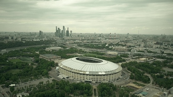 Aerial shot of Moscow cityscape involving famous Luzhniki football stadium and distant skyscrapes