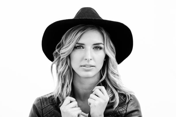Black and white shot of a beautiful woman posing in a studio