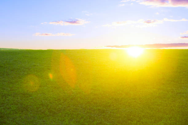 Beautiful sunset on green field and hill.