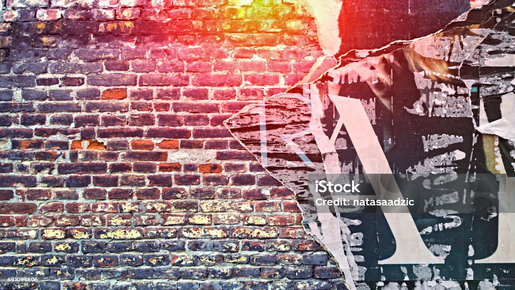 Urban Concrete Brick Wall With Copy Space Urban Concrete Brick Wall With Copy Space. Grunge old wall with torn posters as creative and abstract background. Graffiti Stock Photo