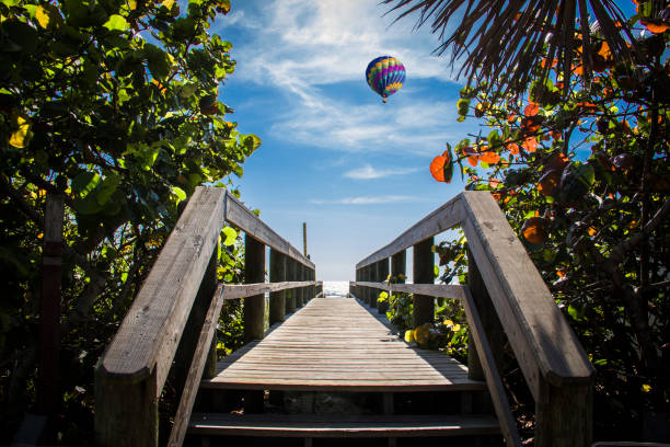 Beach Wooden Walkway Beach entrance in Cocoa Beach Florida. cocoa beach stock pictures, royalty-free photos & images