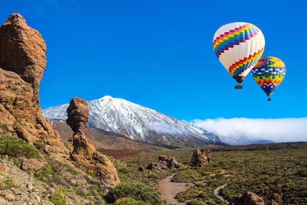 beautiful view of unique roque cinchado unique rock formation with famous volcano teide in the background on a sunny day, teide national park, tenerife, canary islands, spain - sky travel destinations tourism canary islands imagens e fotografias de stock