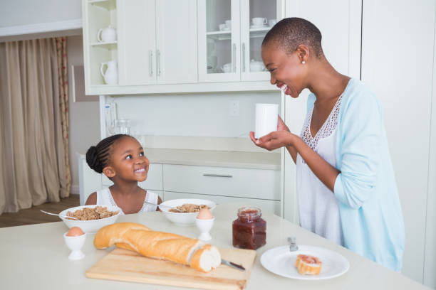 istock Smiling mother and daughter eating together 691103278