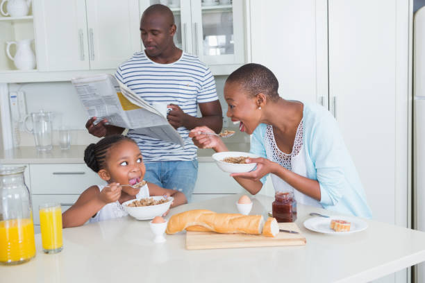 istock Happy family sitting and taking breakfast 691103604