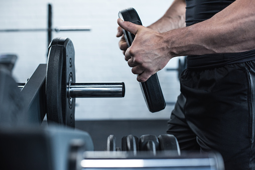 Putting Weight On Object Muscular Man Putting Weight On Dumbbell In Gym Stock Photo - Download ...