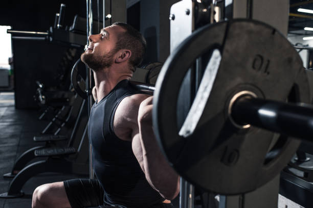 istock sportive man lifting barbell at gym 691108880