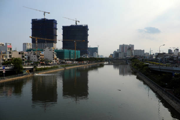 Development of riverside real estate with  many apartment building under construction to meet housing needs in big city, Vietnam