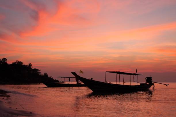 istock beautiful beach sunset with thai boat 691119978