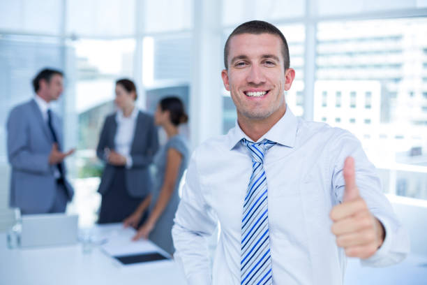 istock Smiling businessman gesturing thumbs up 691126112