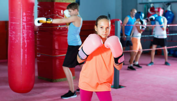 istock Girl in gloves posing during boxing training at gym 691126888
