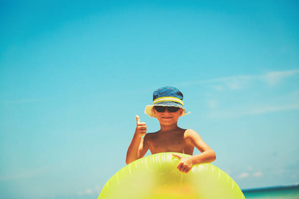 istock happy little boy play at summer beach 691128430