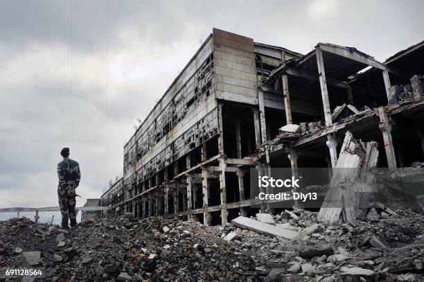 Soldier In Military Uniform Stands On The Ruins Stock Photo - Download Image Now - Ukraine, War, Russia