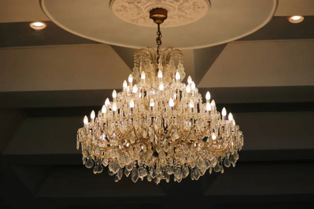 istock Luxury crystal chandelier hanging under ceiling in the room. 691131708