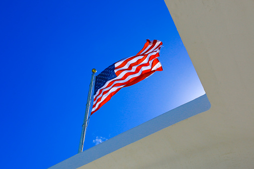 The US flag flies above the USS Arizona Memorial
