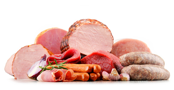 Assorted meat products including ham and sausages isolated on white background