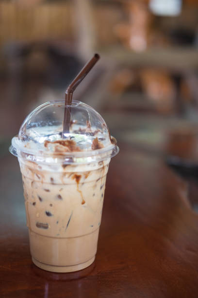 istock iced cocoa in takeaway cup on wooden table background 691170308