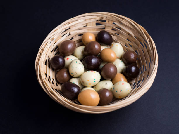 istock Chocolate eggs in basket isolated on black background 691178470