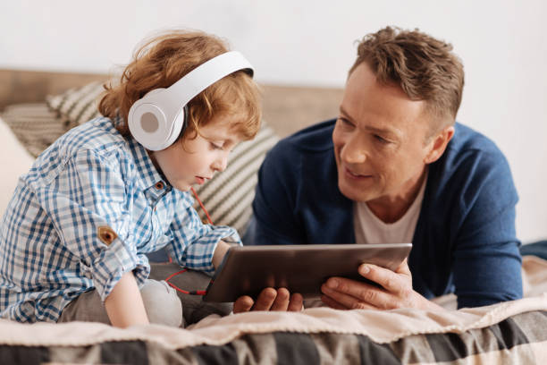 istock Very attentive boy looking at screen of the tablet 691178712