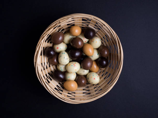 istock Chocolate eggs in basket isolated on black background 691178864