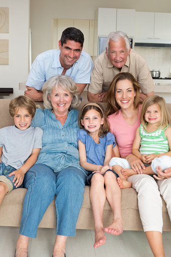 Portrait of happy multigeneration family in sitting room at home
