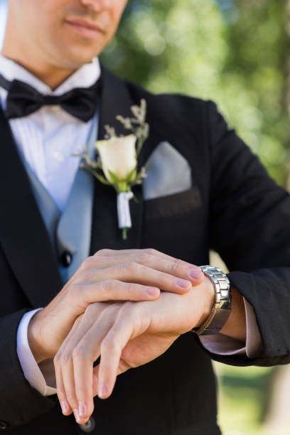 istock Midsection of bridegroom checking time 691187060