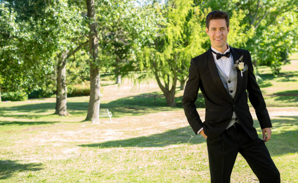 istock Handsome bridegroom standing in garden 691187136