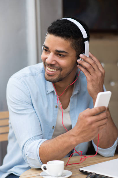 istock Happy African American businessman using phone at cafe 691188720