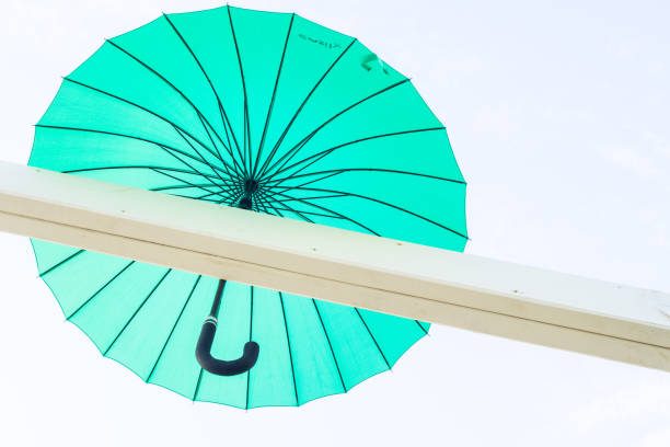 istock Brightly coloured floating umbrellas fill the sky 691193906