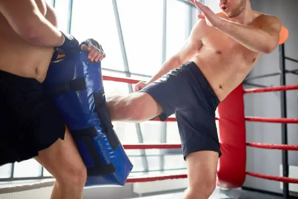 Kick-boxing fighter training with instructor