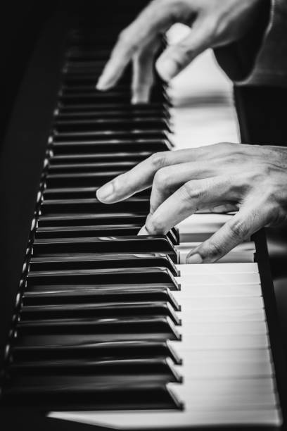istock male musician hands playing on piano keys 691195372
