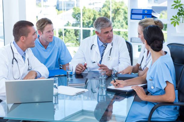 istock Team of doctors working together on patients file 691196068