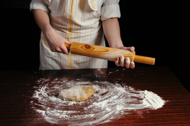 istock Girl in an apron in a dark kitchen. 691196106