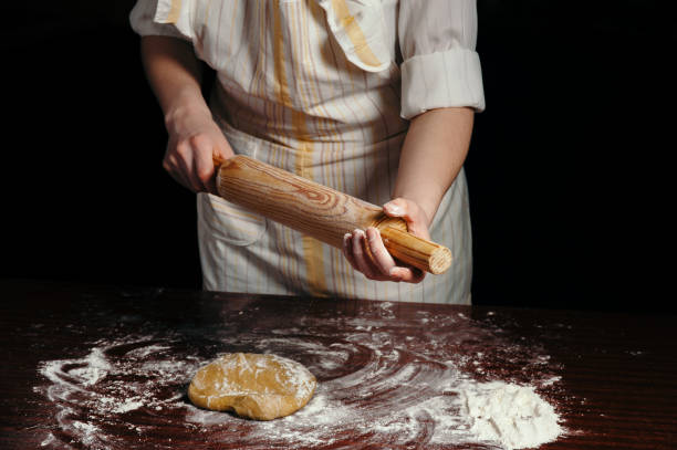 istock Girl in an apron in a dark kitchen. 691199066
