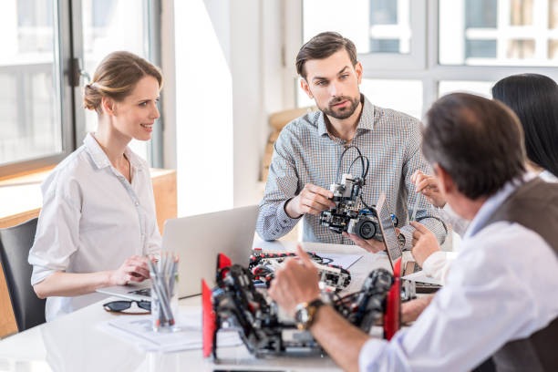 istock Group of inventors discussing in office 691207696