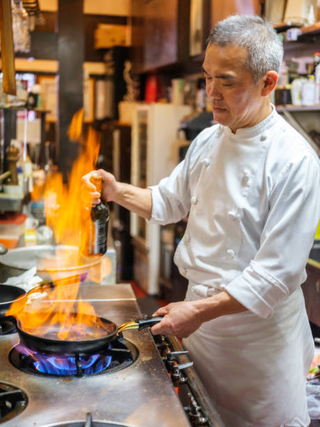 Japanese Chef Working in a Tokyo Restaurant A Japanese chef working in a restaurant in Tokyo, Japan. japanese chef stock pictures, royalty-free photos & images