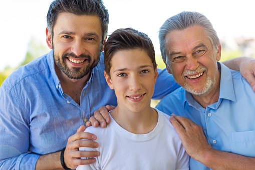 Boy with father and grandfather outdoors