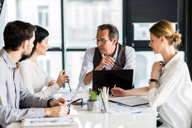 istock Group of confident workers holding meeting in office 691214862