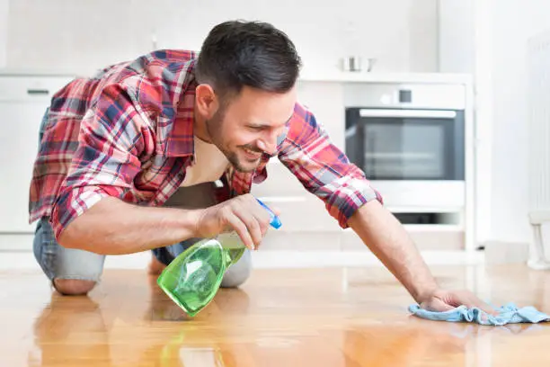 Photo of Man wiping parquet