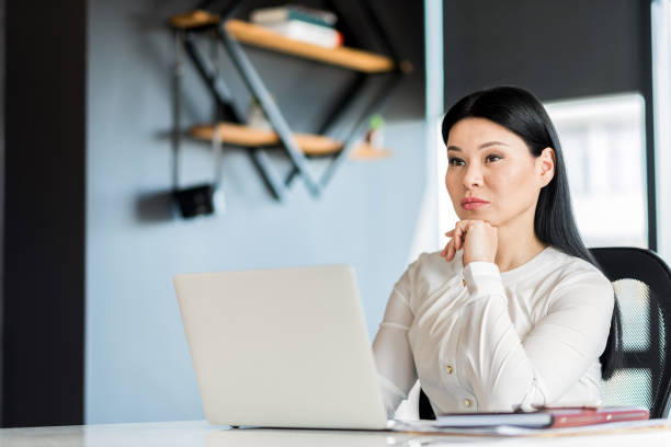 istock Serious charming woman working in office 691215406