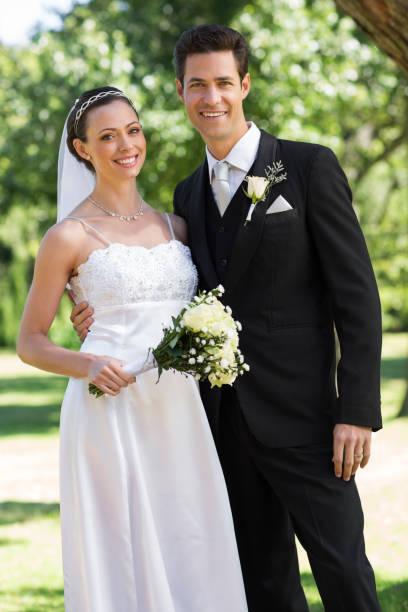istock Newly wed couple standing in garden 691218510