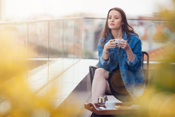 istock Woman drinking coffee on balcony 691218624
